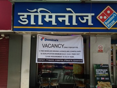 A banner outside a Domino's pizza franchise in India seeking delivery personnel reads: VACANCY (Only for boyys)